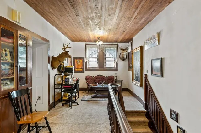 a very nice looking room with many windows and furniture