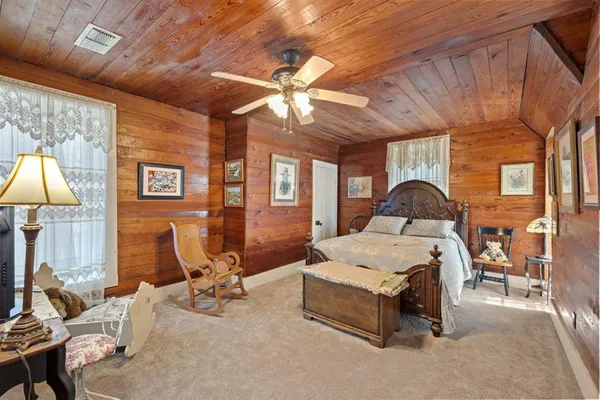 a room with furniture a chandelier and a flat screen tv