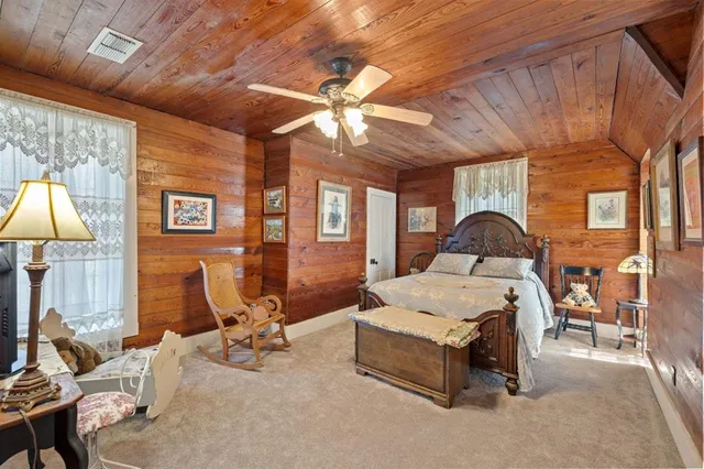 a room with furniture a chandelier and a flat screen tv