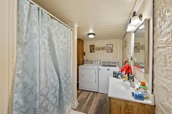 a living room with a sink and dryer next to a window