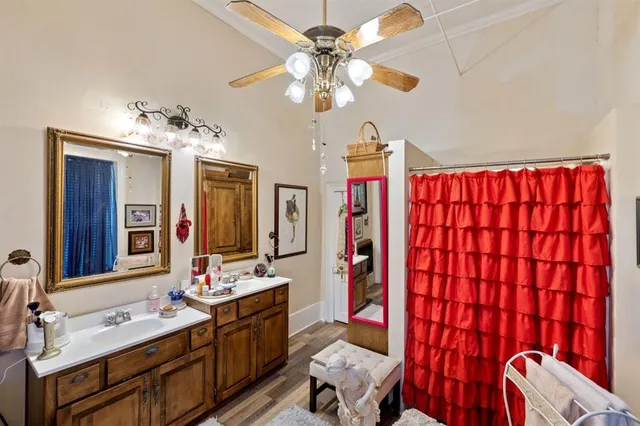 a bathroom with a sink vanity mirror and shower
