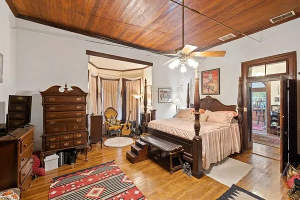 a bedroom with bed and a chandelier