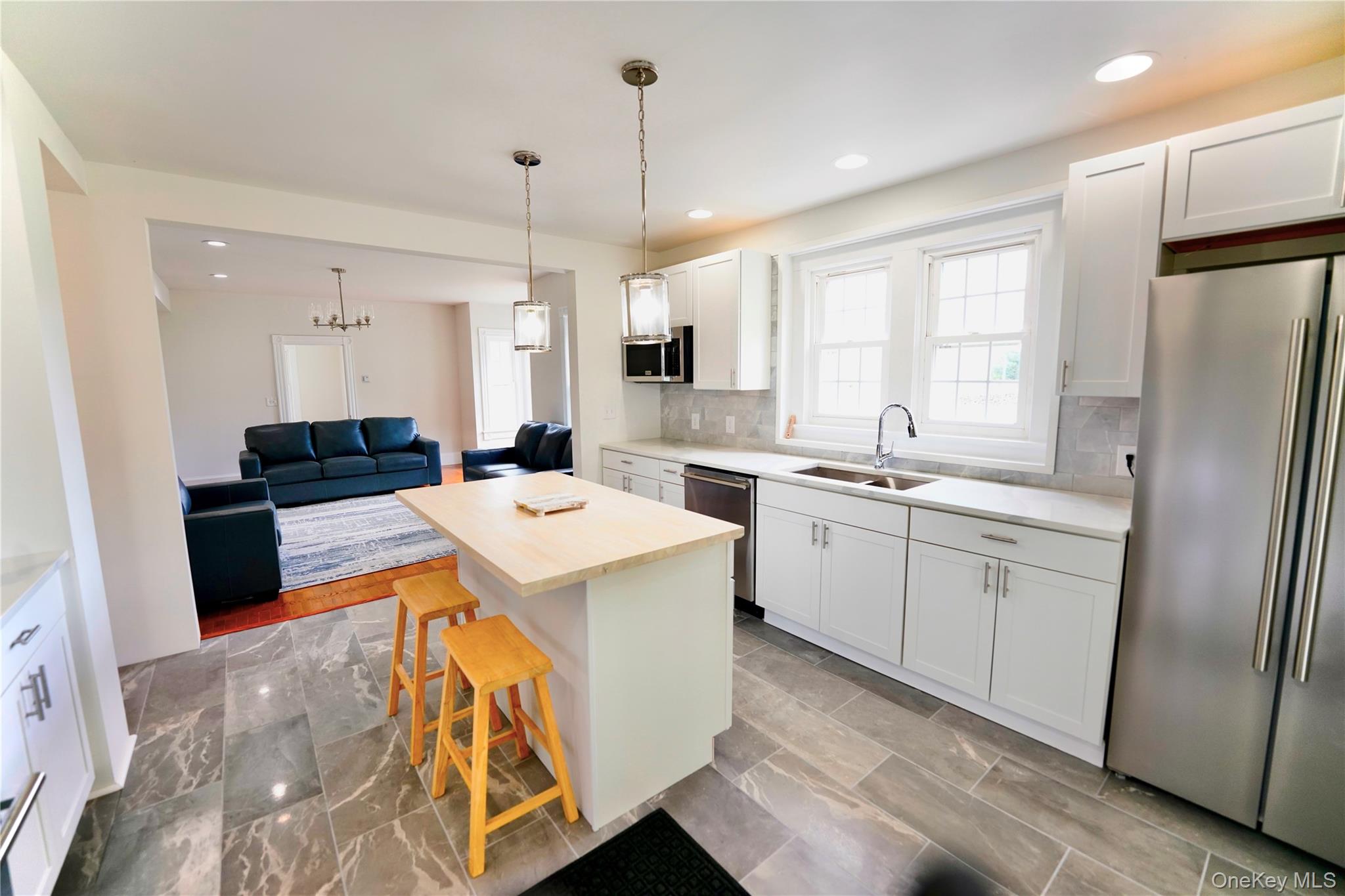 70 Royce Road Bethel, NY 12786 - Photo 13 of 48 a open kitchen with stainless steel appliances granite countertop a refrigerator a sink a stove and white cabinets