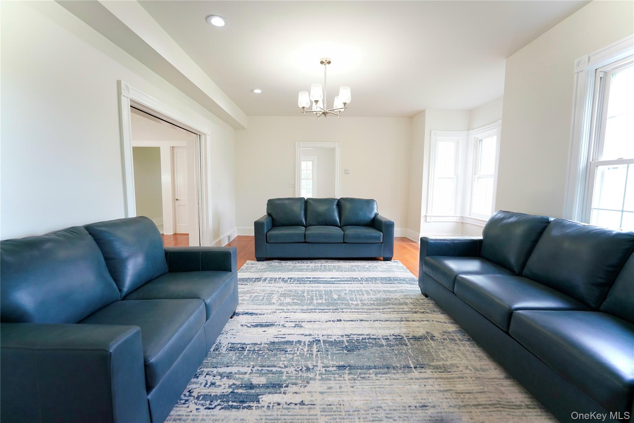 70 Royce Road Bethel, NY 12786 - Photo 19 of 48 a living room with furniture and a chandelier