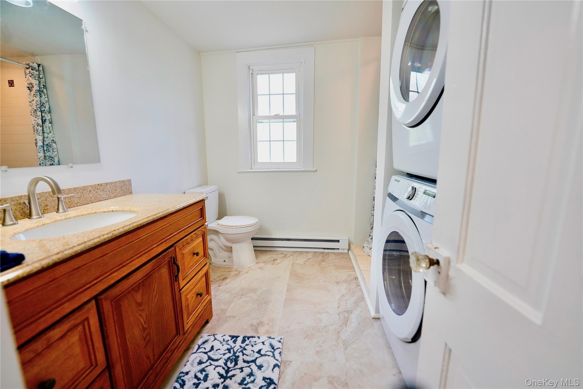 70 Royce Road Bethel, NY 12786 - Photo 23 of 48 a bathroom with a sink a washer and dryer