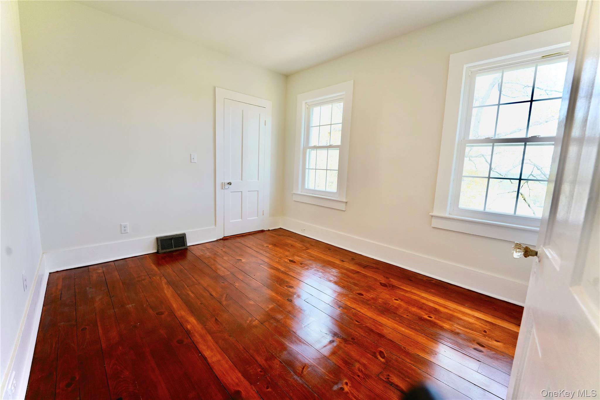 70 Royce Road Bethel, NY 12786 - Photo 28 of 48 an empty room with wooden floor and windows
