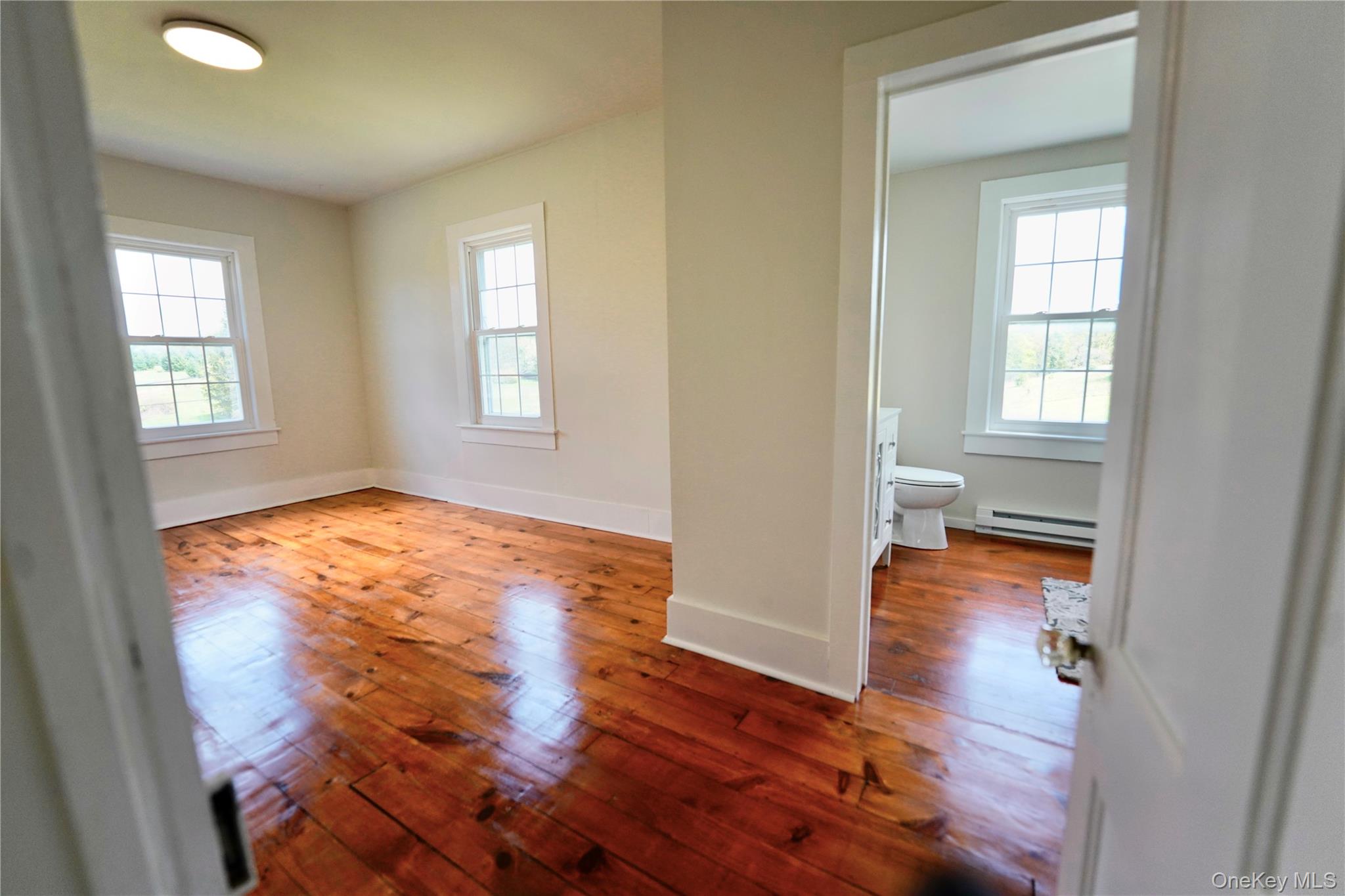 70 Royce Road Bethel, NY 12786 - Photo 29 of 48 an empty room with wooden floor and a window