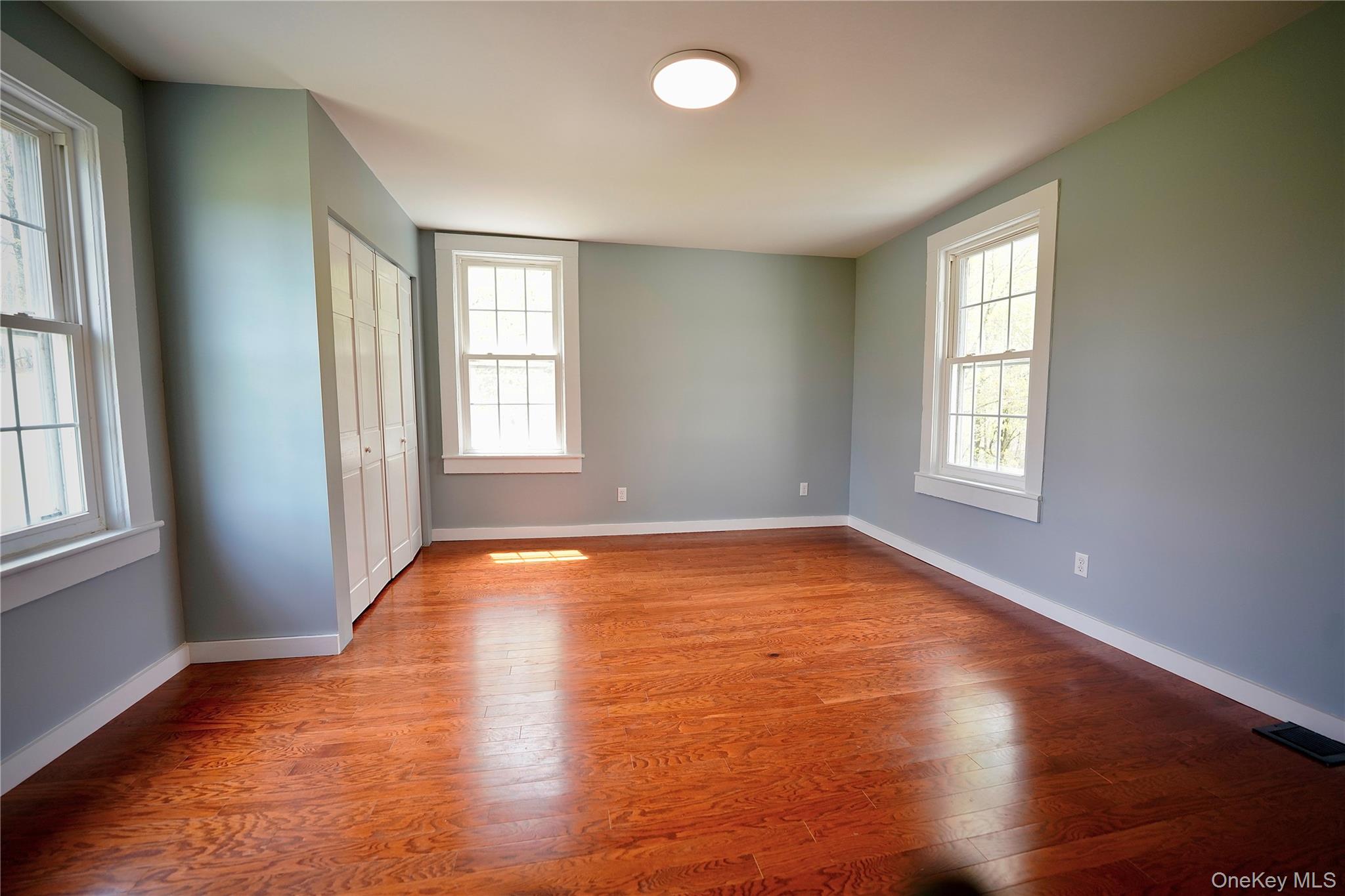 70 Royce Road Bethel, NY 12786 - Photo 32 of 48 an empty room with wooden floor and windows