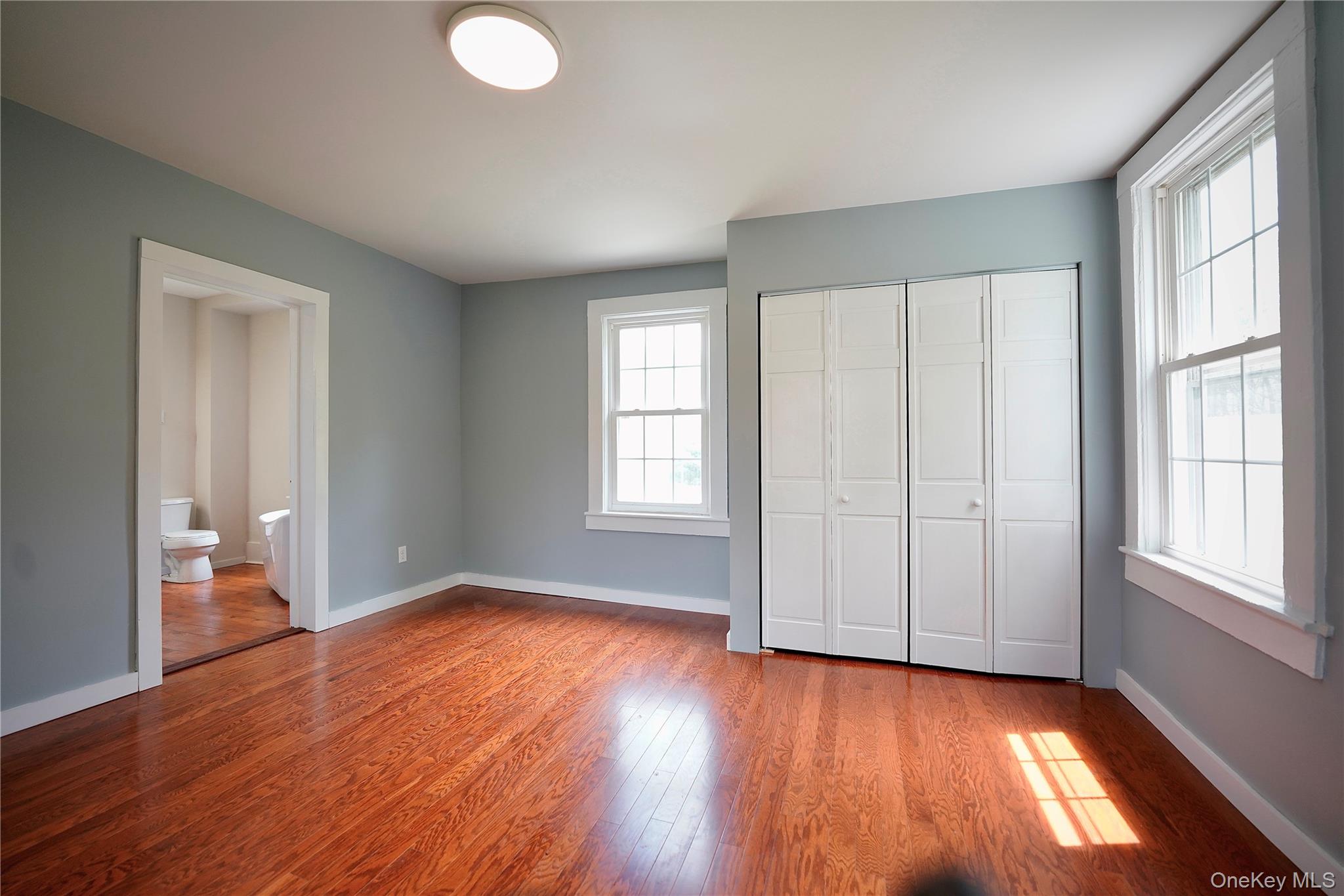 70 Royce Road Bethel, NY 12786 - Photo 33 of 48 an empty room with wooden floor and windows