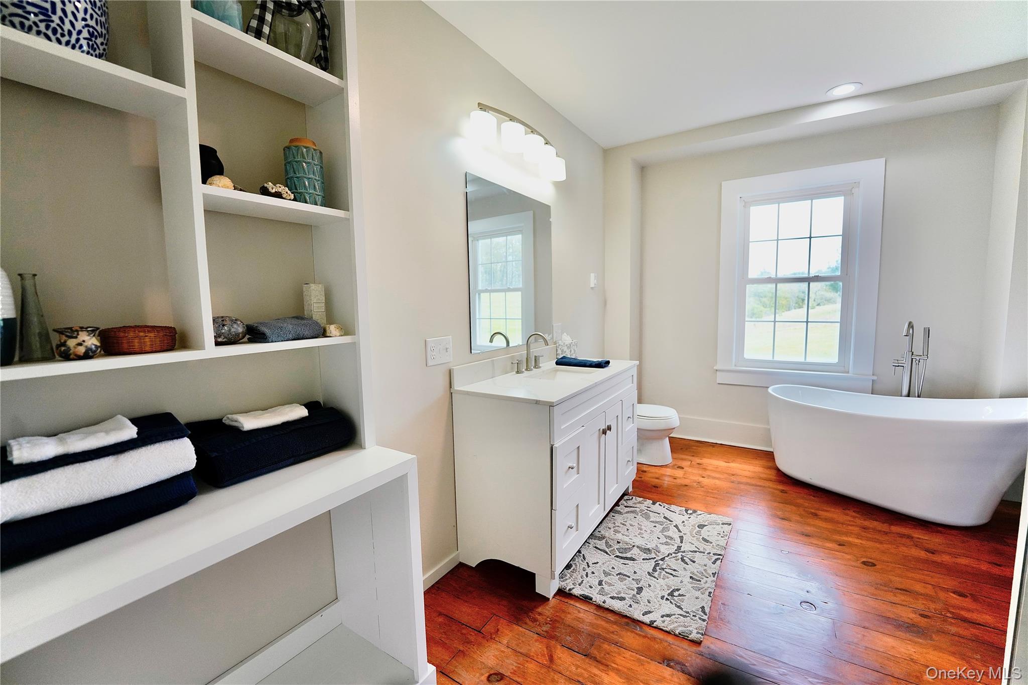 70 Royce Road Bethel, NY 12786 - Photo 34 of 48 a bathroom with a tub double vanity sink and mirror
