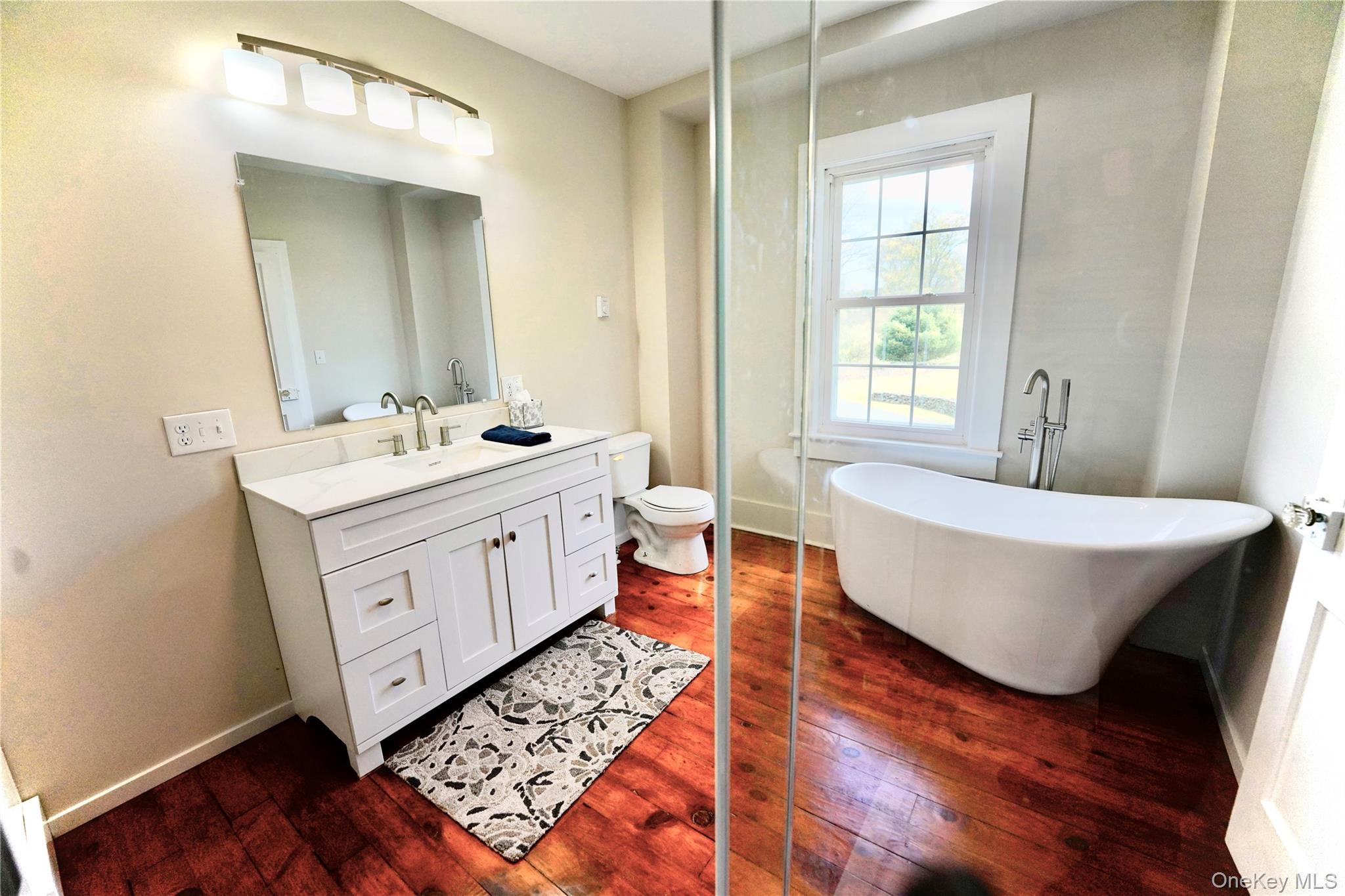 70 Royce Road Bethel, NY 12786 - Photo 36 of 48 a spacious bathroom with double vanity sink a mirror and a bathtub