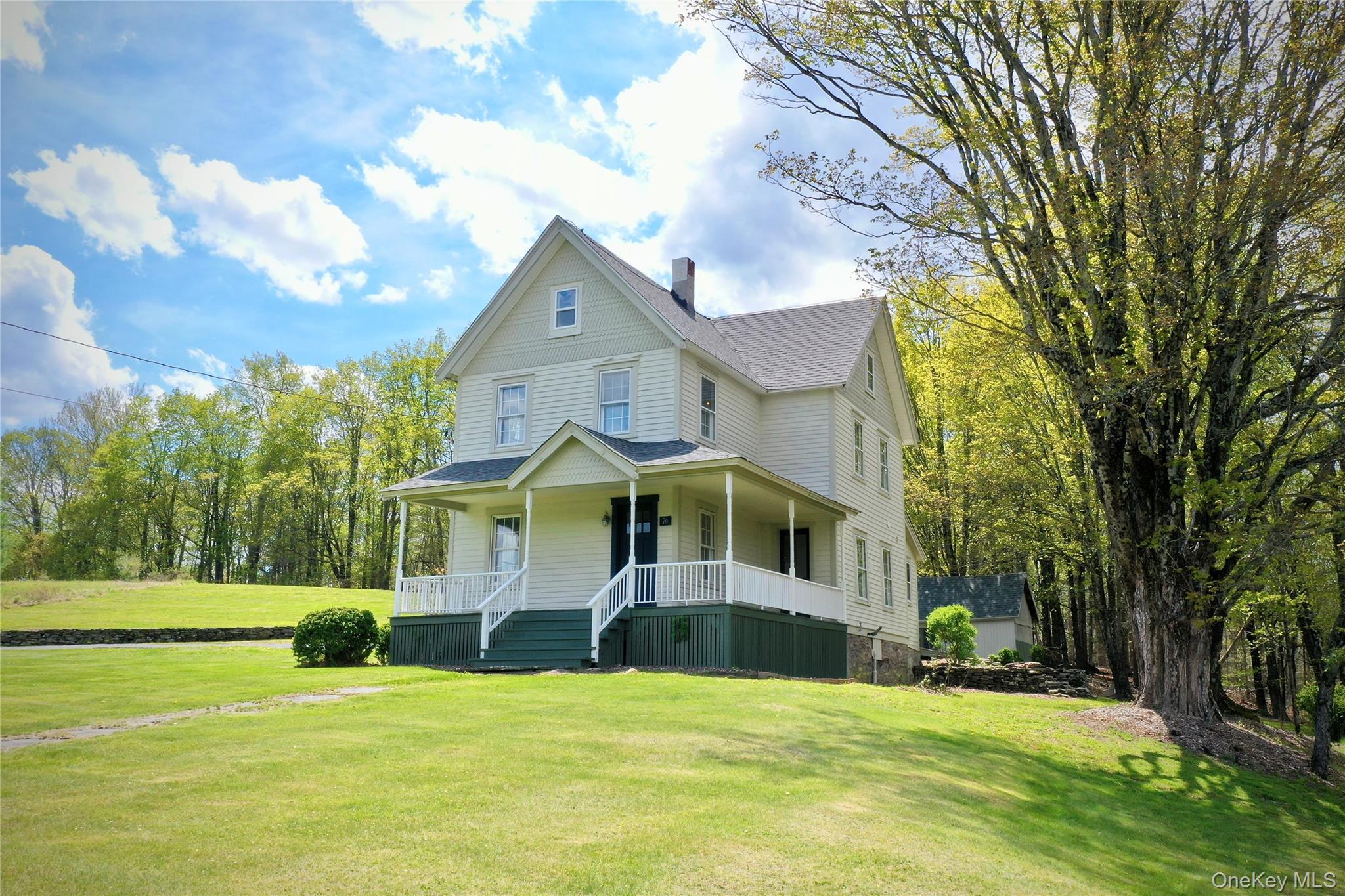 70 Royce Road Bethel, NY 12786 - Photo 9 of 48 a front view of a house with a yard