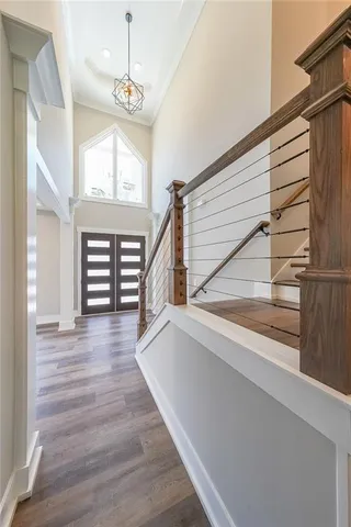 a view of entryway and hall with wooden floor