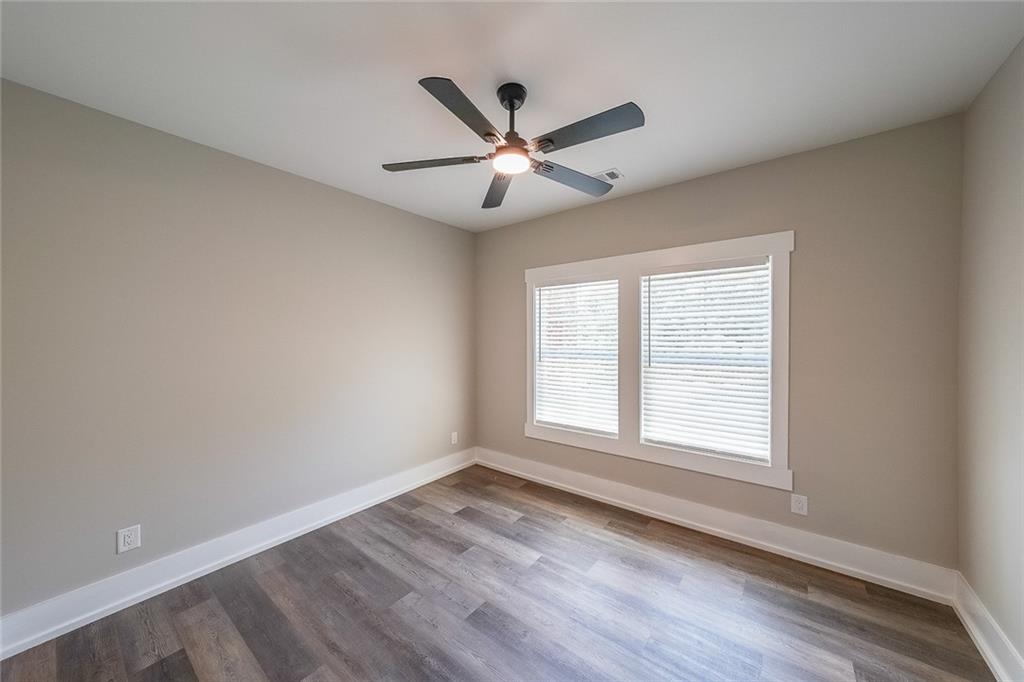 1360 Dickens Road Northwest Lilburn, GA 30047 - Photo 20 of 45 wooden floor in an empty room with a window