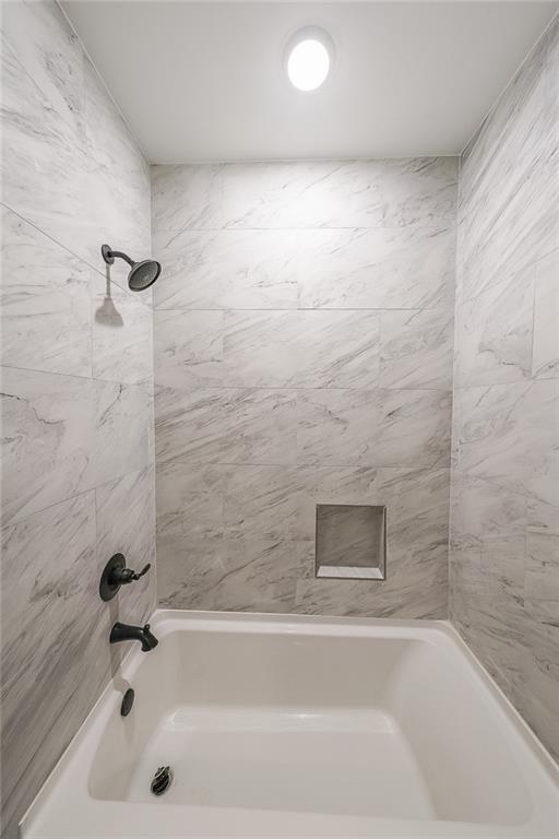 1360 Dickens Road Northwest Lilburn, GA 30047 - Photo 22 of 45 a bathroom with a bathtub