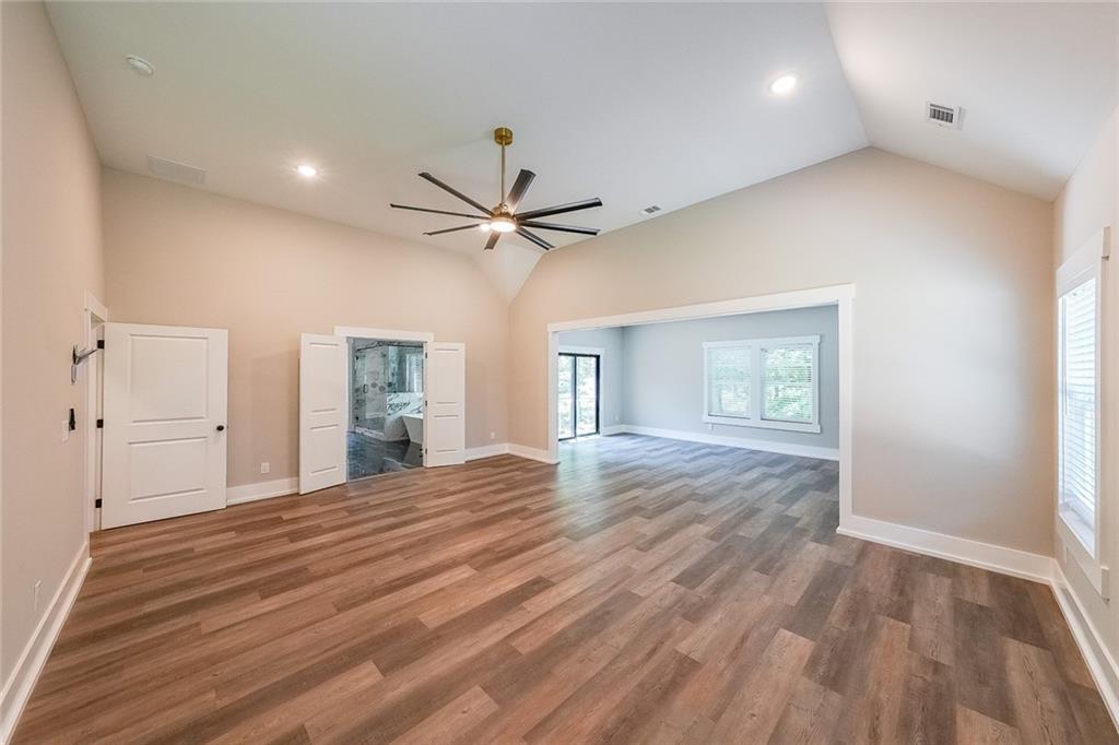 1360 Dickens Road Northwest Lilburn, GA 30047 - Photo 25 of 45 a view of a livingroom with a hardwood floor and a ceiling fan
