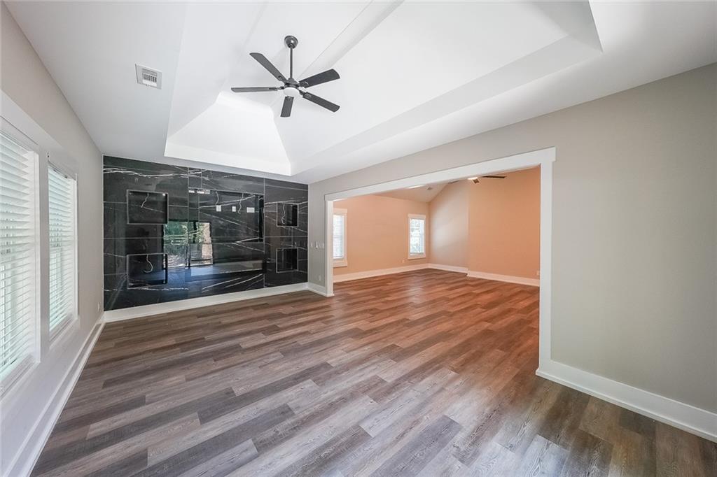 1360 Dickens Road Northwest Lilburn, GA 30047 - Photo 26 of 45 a view of an empty room with wooden floor and a window
