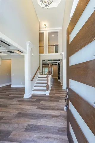 a view of entryway and hall with wooden floor