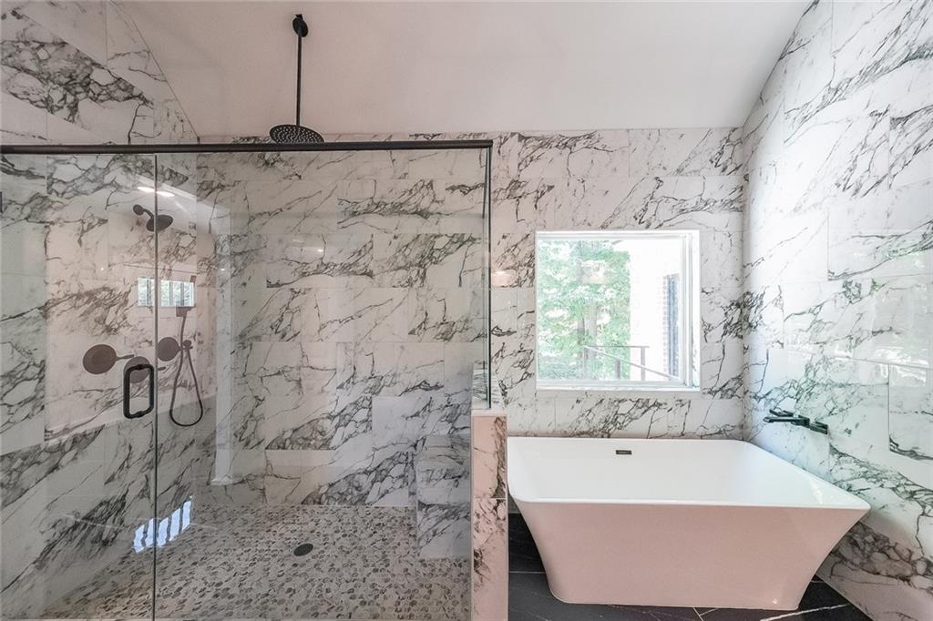 1360 Dickens Road Northwest Lilburn, GA 30047 - Photo 31 of 45 a bathroom with a bathtub and shower