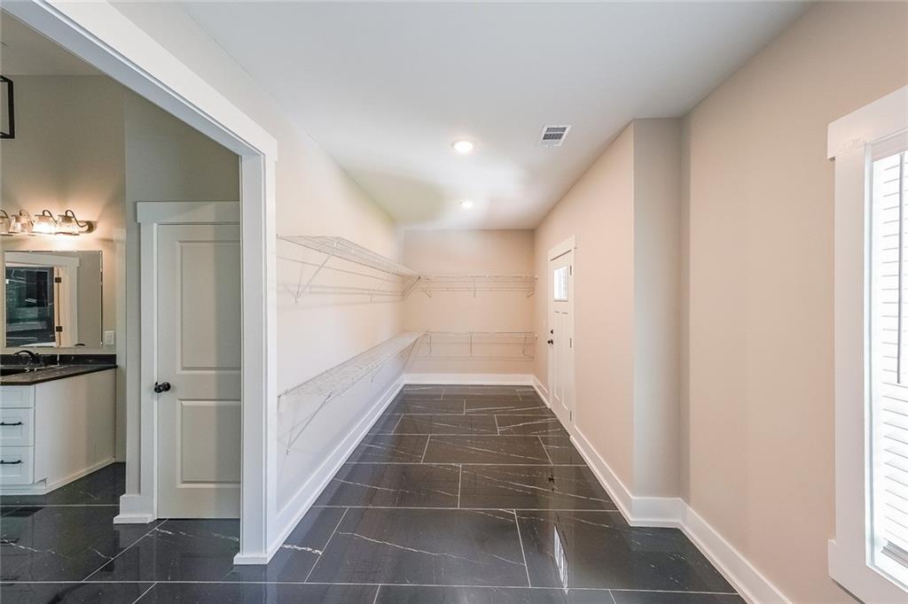 1360 Dickens Road Northwest Lilburn, GA 30047 - Photo 32 of 45 a view of a hallway with wooden floor and staircase