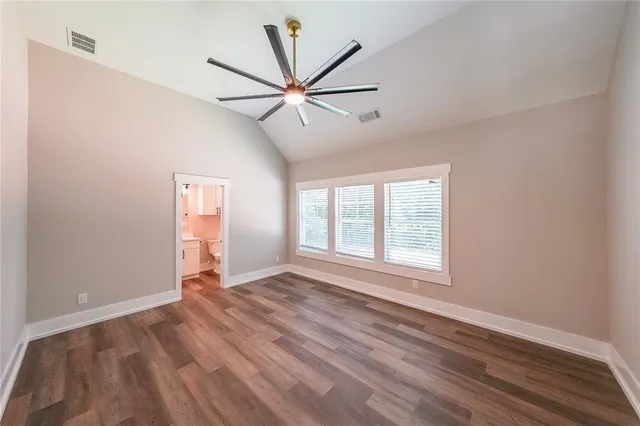 a bathroom with a sink a toilet a mirror and shower