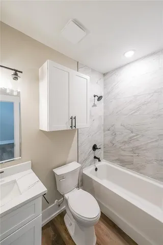 a view of an empty room with a window and a chandelier fan