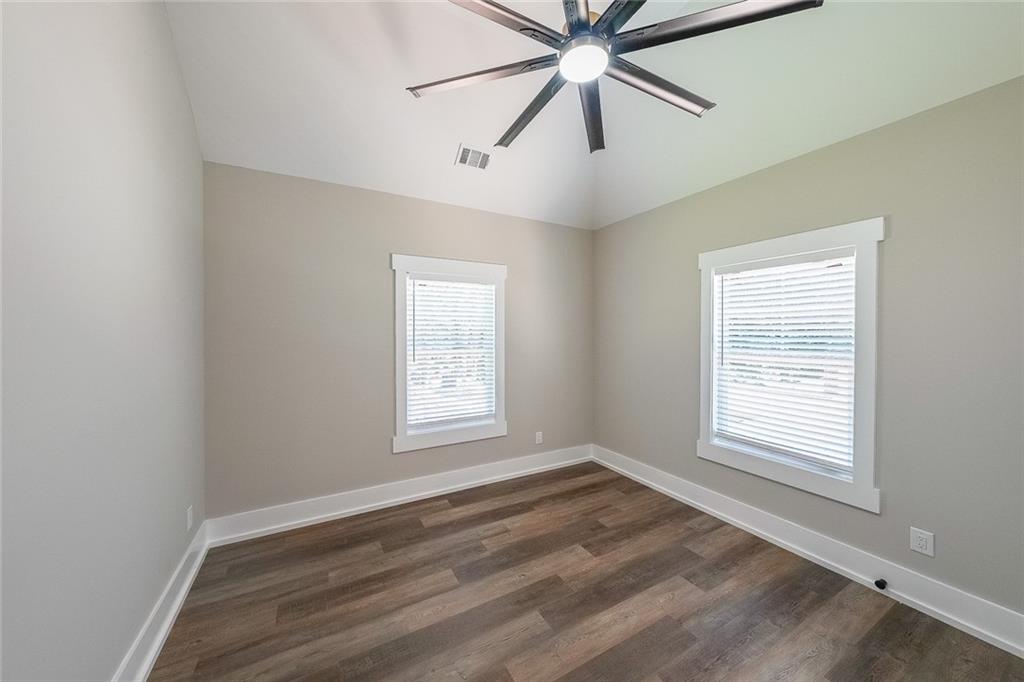 1360 Dickens Road Northwest Lilburn, GA 30047 - Photo 38 of 45 a view of an empty room with a window and a chandelier fan