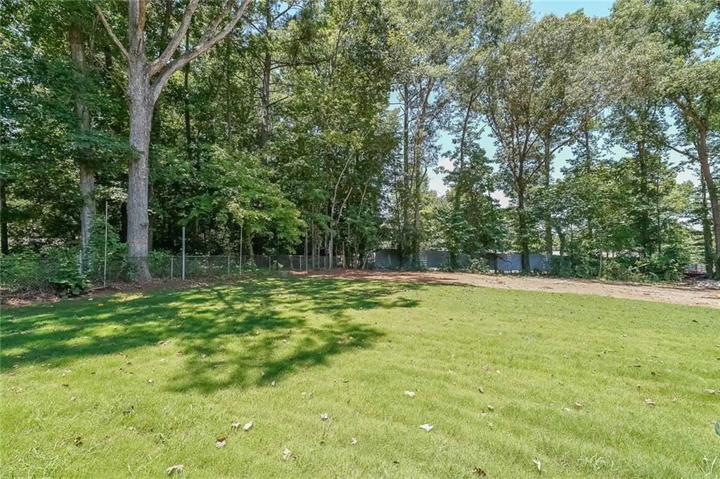 1360 Dickens Road Northwest Lilburn, GA 30047 - Photo 44 of 45 a view of a large yard with large trees