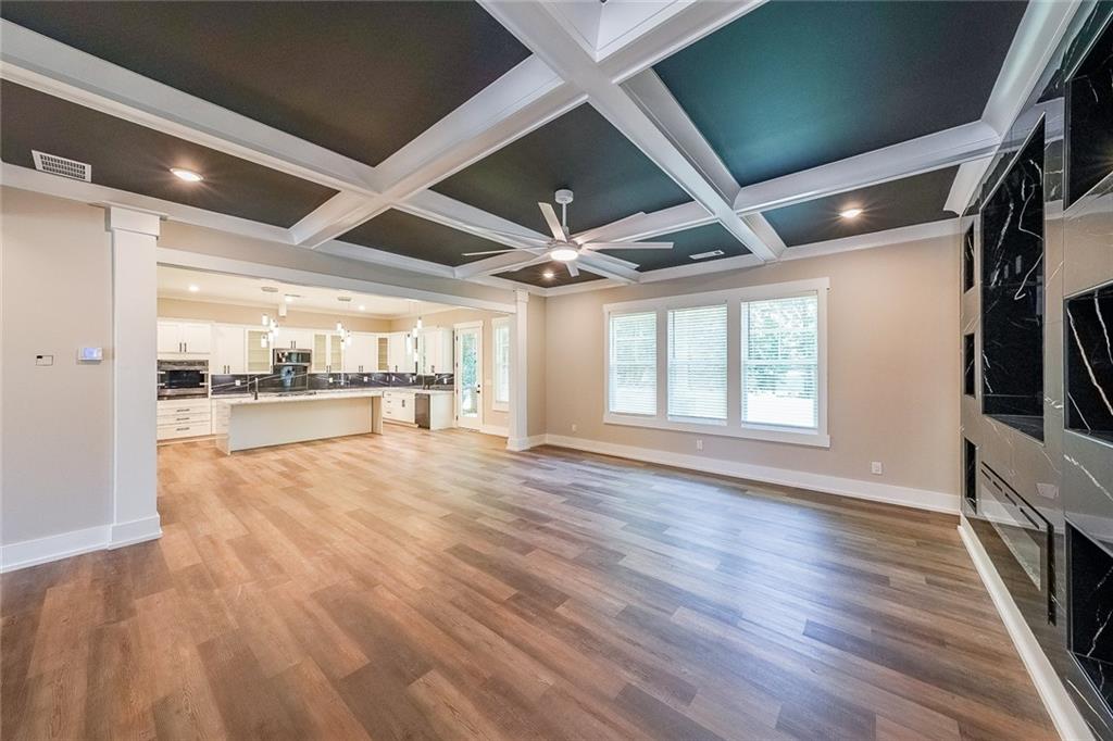 1360 Dickens Road Northwest Lilburn, GA 30047 - Photo 6 of 45 a view of an empty room with a window and wooden floor