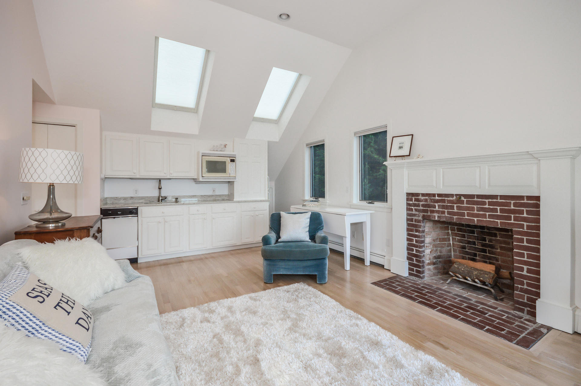 47 Gunning Point Road Falmouth, MA 02540 - Photo 22 of 33 a living room with furniture a fireplace and a table