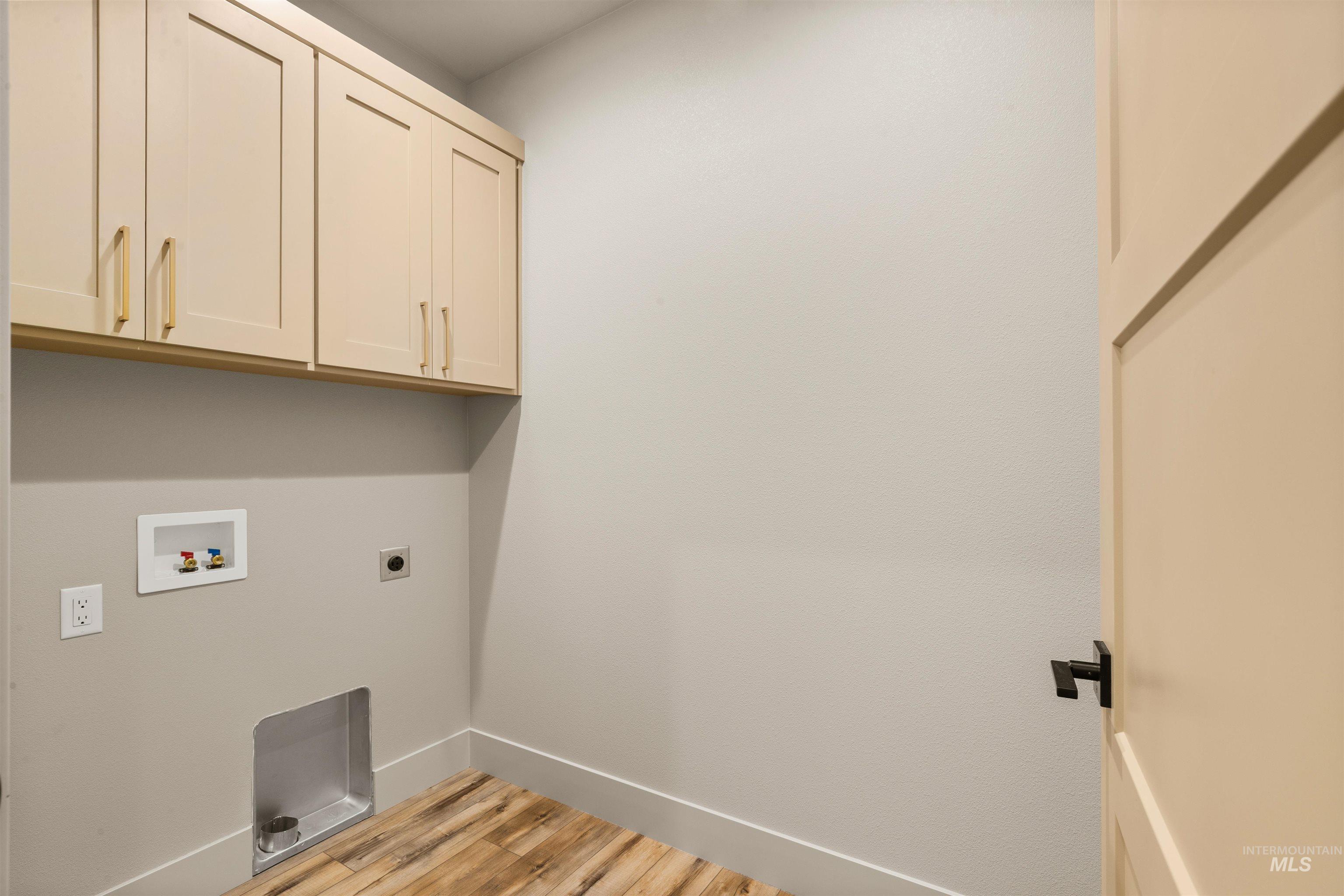 335 Warner Avenue Lewiston, ID 83501 - Photo 39 of 43 Laundry area with light wood finished floors, cabinet space, hookup for an electric dryer, and hookup for a washing machine