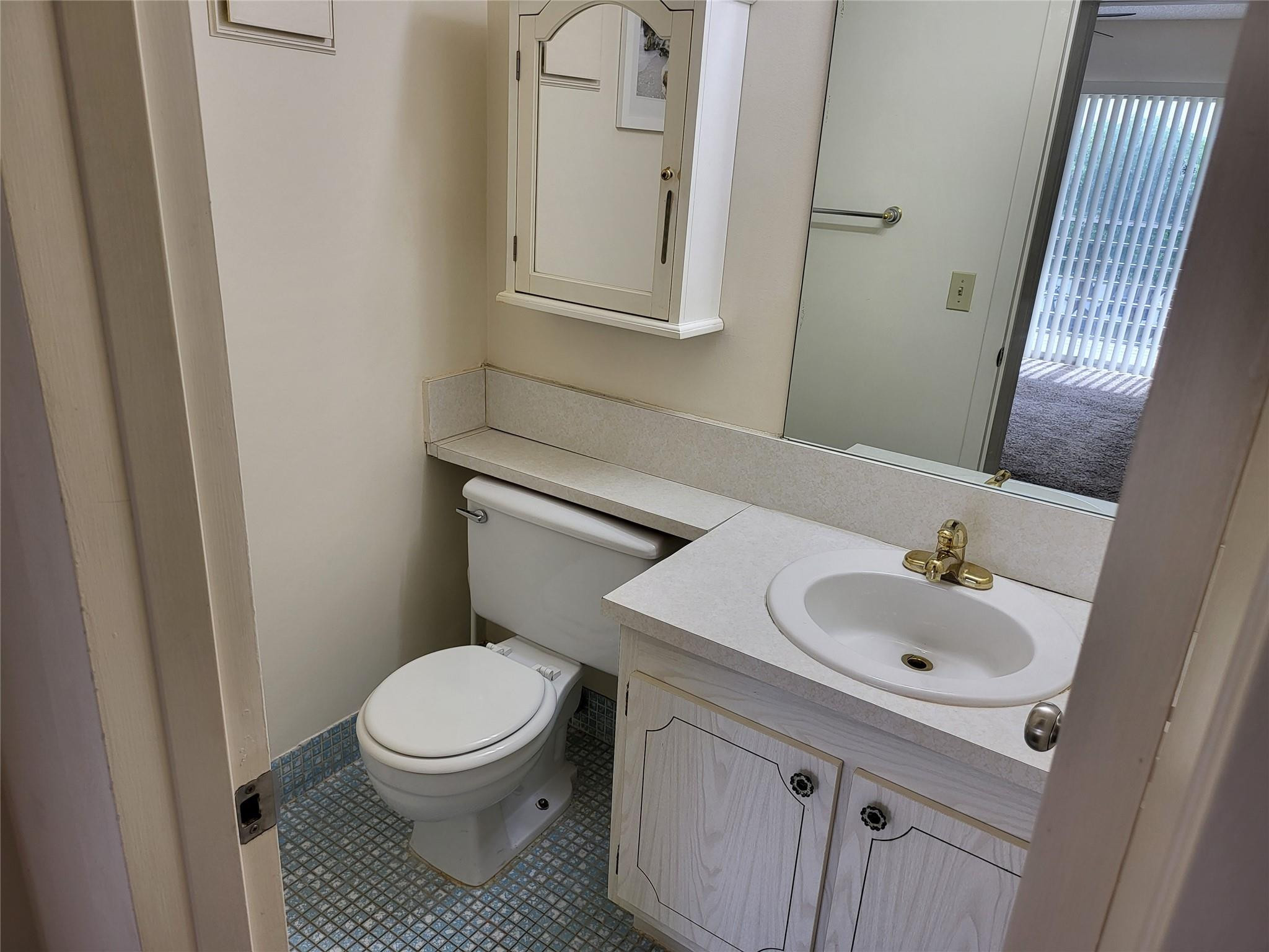 82 Dorset B, Unit 82 Boca Raton, FL 33434 - Photo 18 of 18 a white toilet sitting next to a bathroom sink