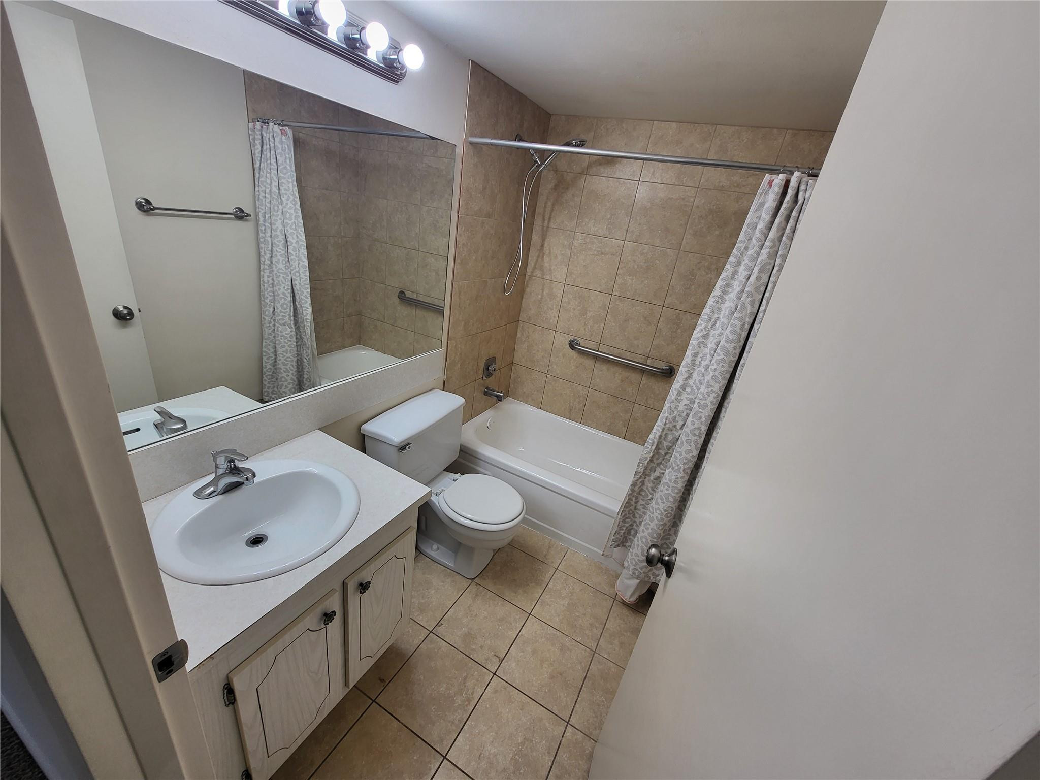 82 Dorset B, Unit 82 Boca Raton, FL 33434 - Photo 10 of 18 a bathroom with a sink a toilet and shower