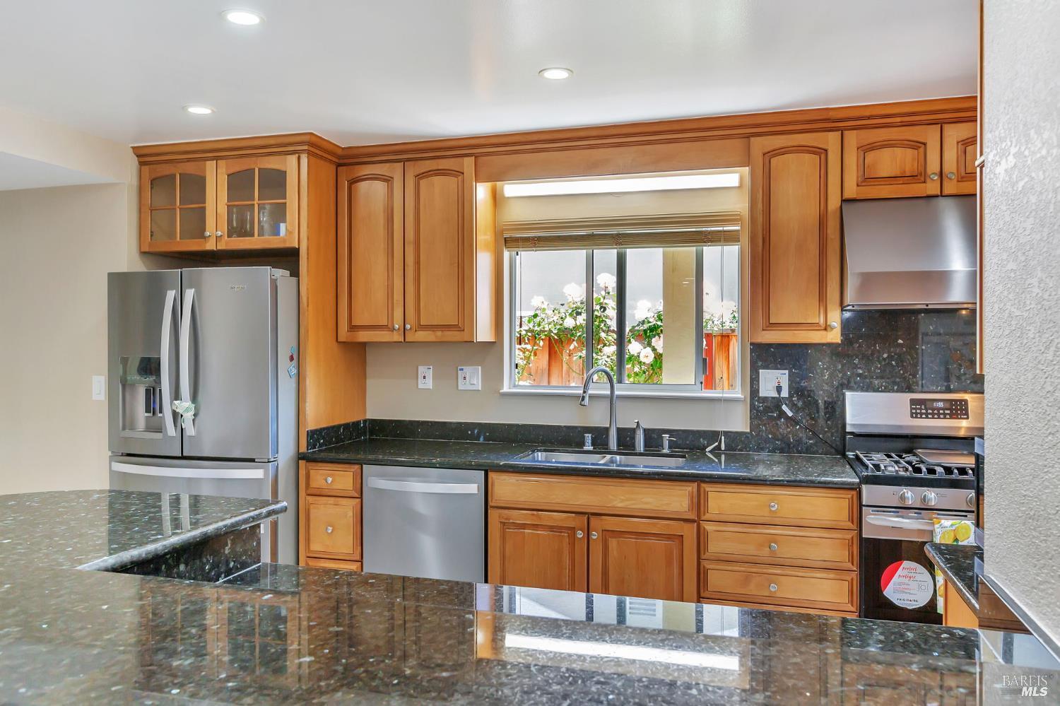 99 San Benito Way Novato, CA 94945 - Photo 5 of 30 a kitchen with stainless steel appliances granite countertop a refrigerator and a sink