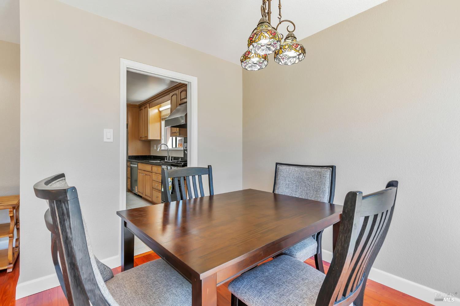 99 San Benito Way Novato, CA 94945 - Photo 7 of 30 a view of a dining room with furniture and wooden floor