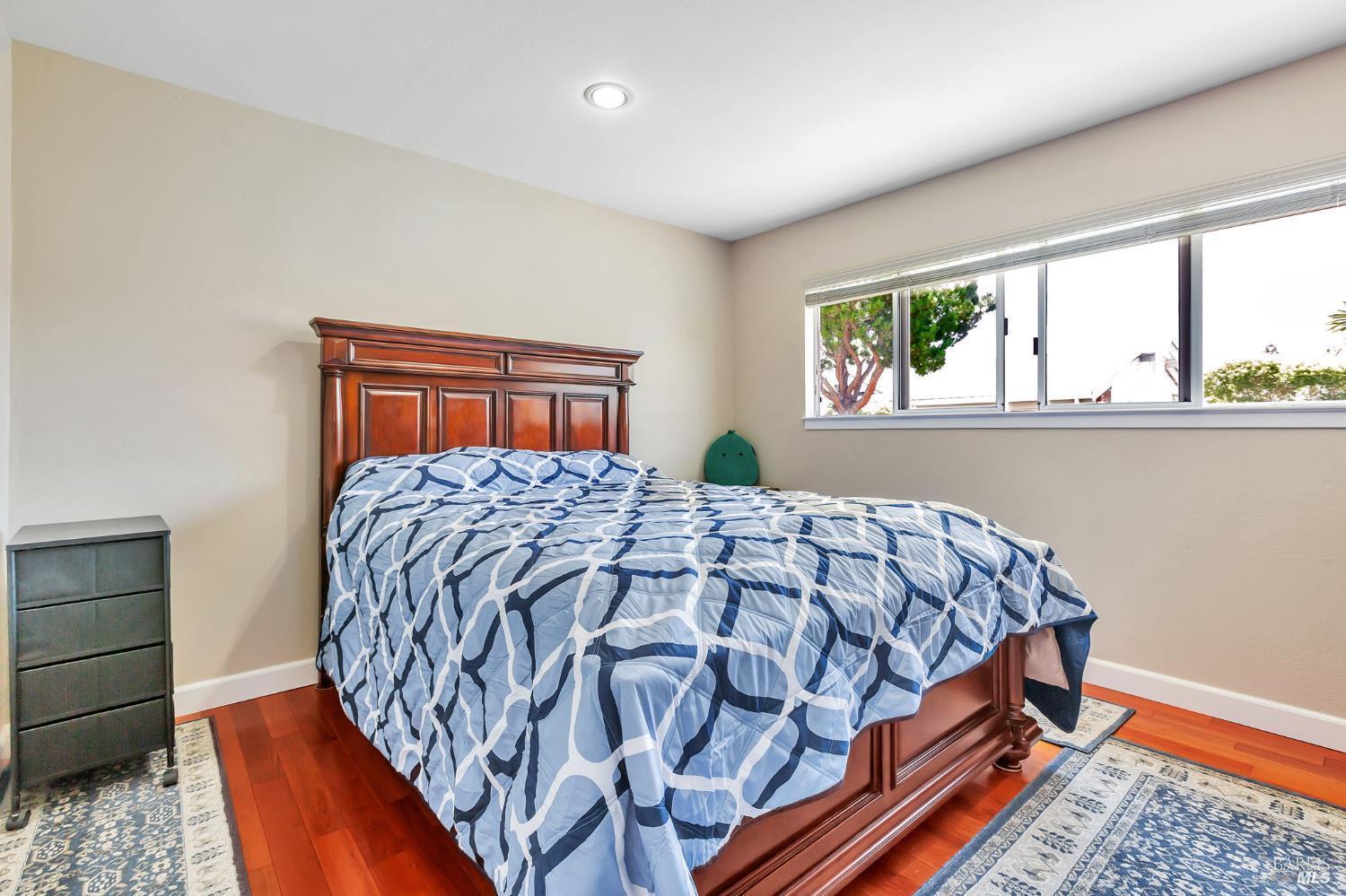 99 San Benito Way Novato, CA 94945 - Photo 10 of 30 a bed sitting in a bedroom next to a window