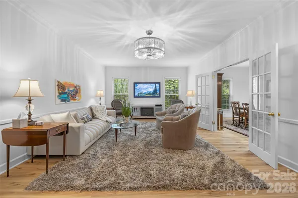 a living room with furniture a window and a lamp