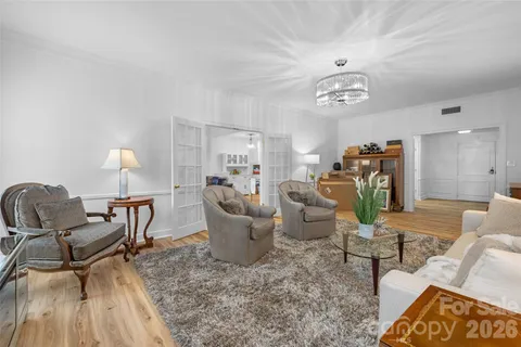 a living room with furniture a dining table and a fireplace