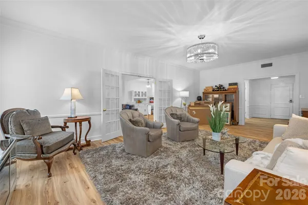 a living room with furniture a dining table and a fireplace