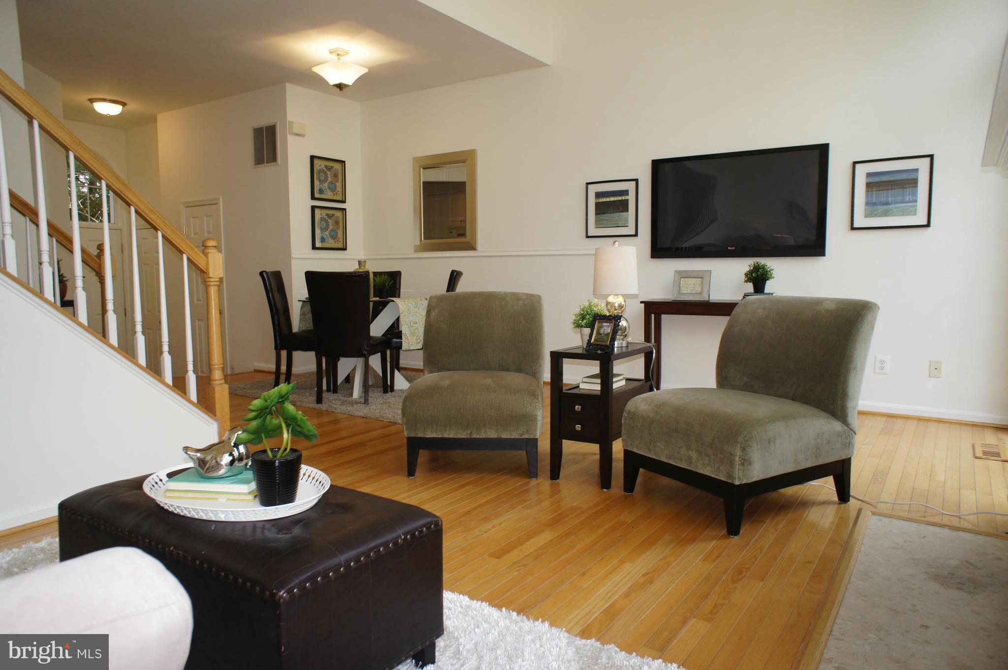 6021 Riddle Walk Alexandria, VA 22312 - Photo 11 of 30 a living room with furniture potted plant and a flat screen tv