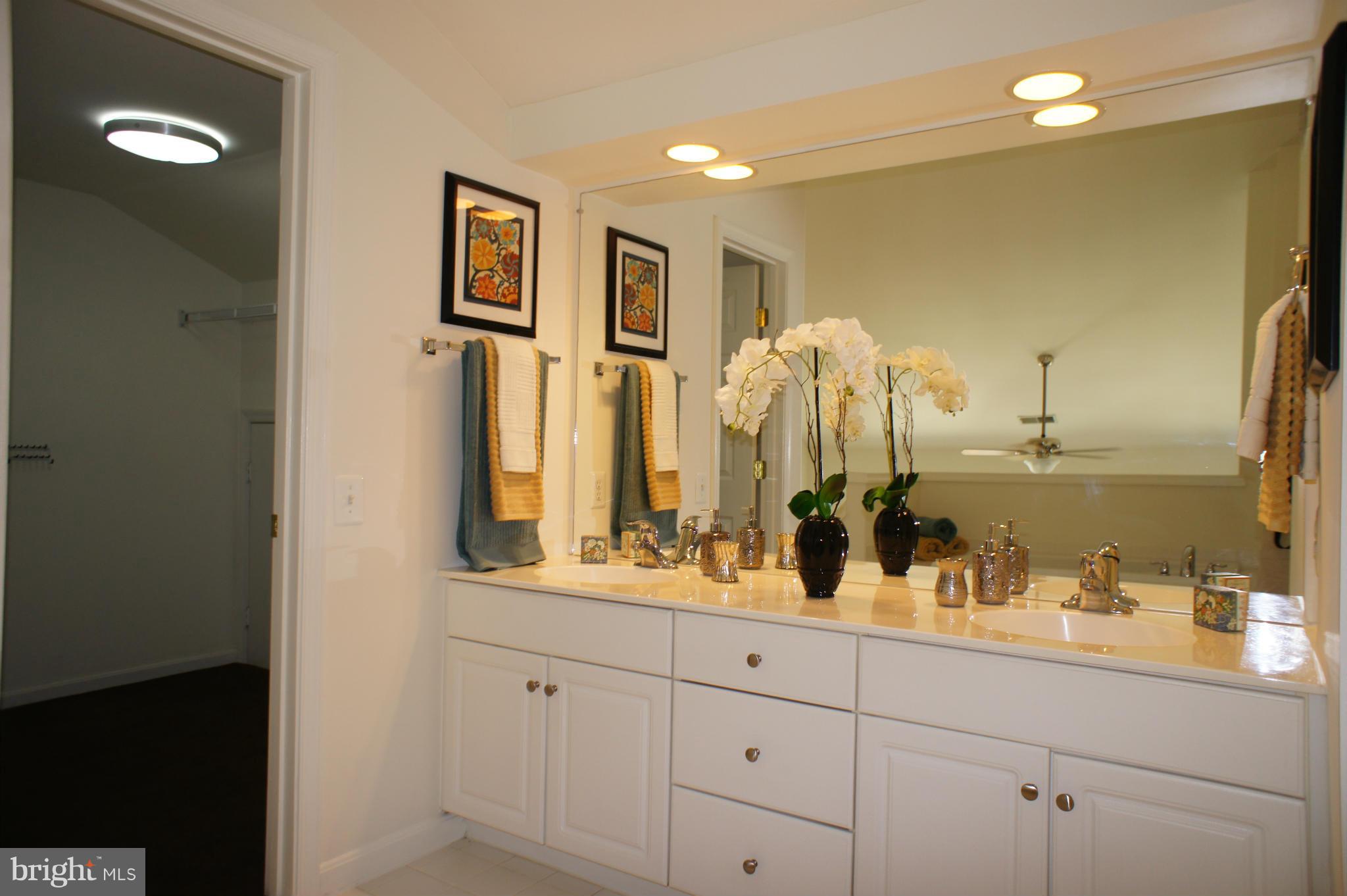 6021 Riddle Walk Alexandria, VA 22312 - Photo 18 of 30 a bathroom with double vanity sinks a vanity two mirror and a shower
