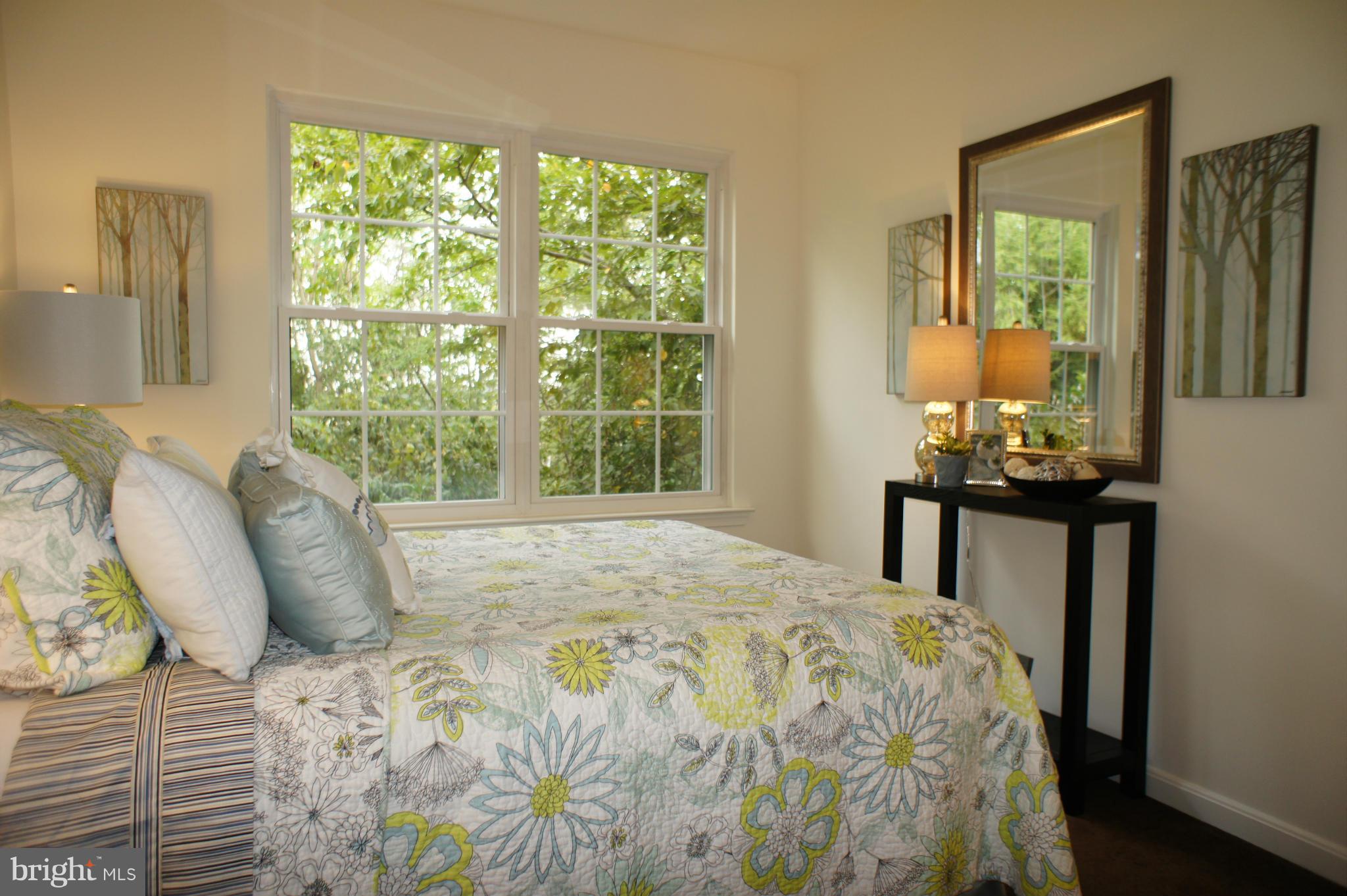 6021 Riddle Walk Alexandria, VA 22312 - Photo 20 of 30 a bedroom with a bed and wooden floor
