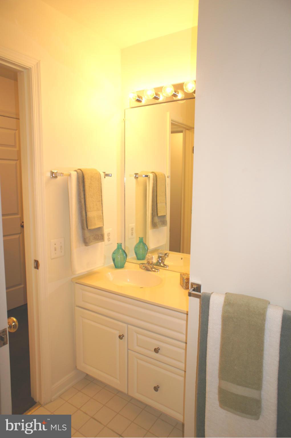 6021 Riddle Walk Alexandria, VA 22312 - Photo 23 of 30 a bathroom with a granite countertop sink and a mirror
