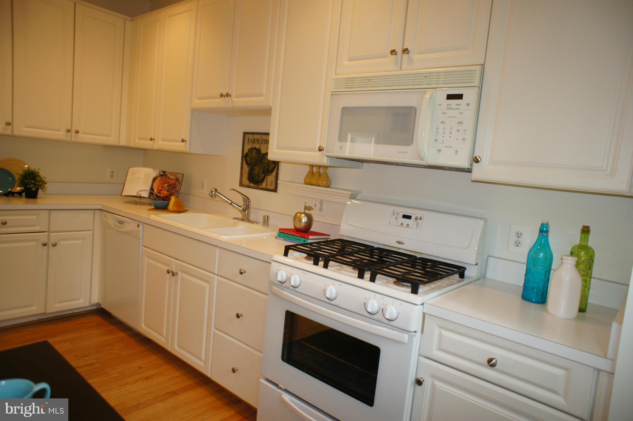 6021 Riddle Walk Alexandria, VA 22312 - Photo 6 of 30 a kitchen with white cabinets and white appliances