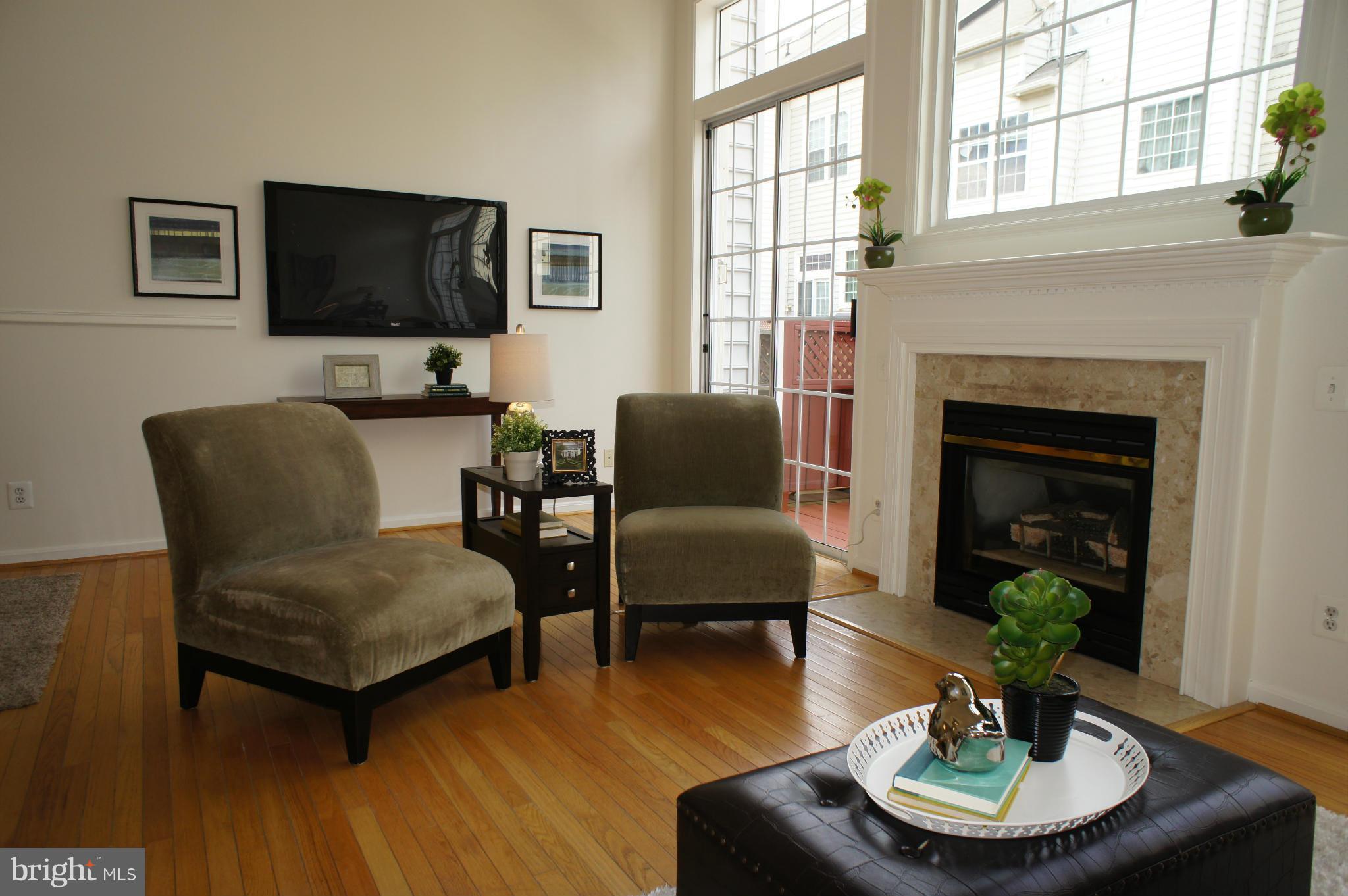 6021 Riddle Walk Alexandria, VA 22312 - Photo 10 of 30 a living room with furniture a fireplace and a flat screen tv