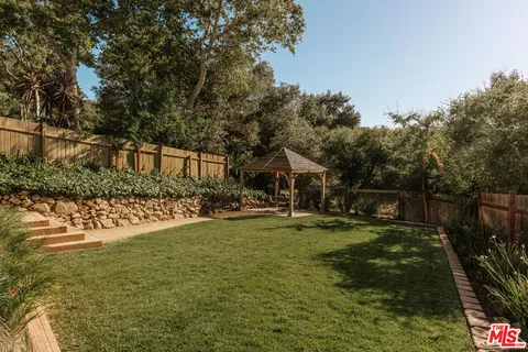 a view of a house with yard and sitting area