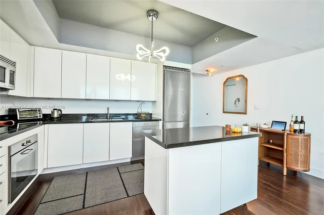 a kitchen with stainless steel appliances a stove refrigerator sink and cabinets