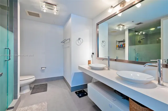a bathroom with a sink double vanity and a toilet