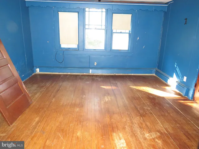 a view of a room with wooden floor and window