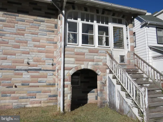 a view of front door of house with stairs